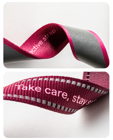 Comparison of two rPET reflective lanyard straps from the Reflect collection: T16 strap with woven reflective thread and a strap with a seamless heat-applied reflective stripe.
