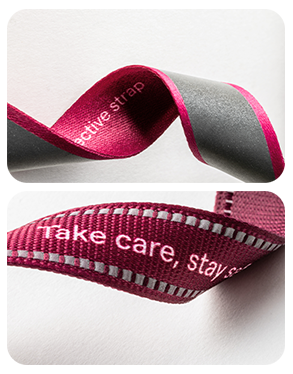 Comparison of two rPET reflective lanyard straps from the Reflect collection: T16 strap with woven reflective thread and a strap with a seamless heat-applied reflective stripe.