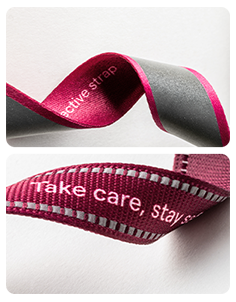 Comparison of two rPET reflective lanyard straps from the Reflect collection: T16 strap with woven reflective thread and a strap with a seamless heat-applied reflective stripe.