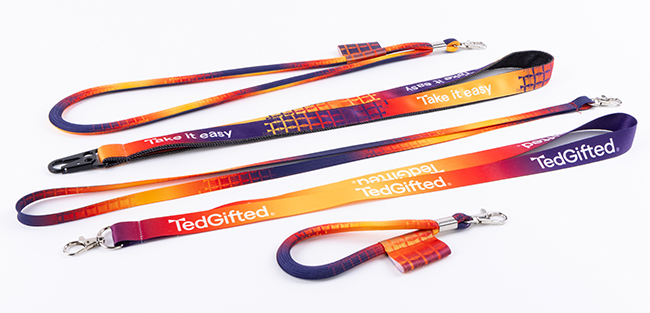 Branded sublimation lanyards featuring full-colour gradient print and metal carabiner clips for company badges.