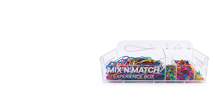 Transparent MIX'n'MATCH Experience Box display filled with colorful straps, clips, and attachments for custom promotional lanyard configuration.